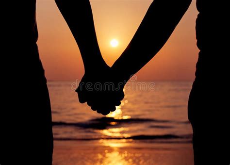 silhouette of a couple holding hands